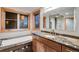 Bathroom featuring a tub, wood trim windows, and a stone countertop at 3428 W County Road 4, Berthoud, CO 80513