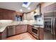 Bright kitchen featuring wooden cabinets, stainless steel appliances, granite countertops, and a skylight at 3428 W County Road 4, Berthoud, CO 80513