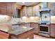 Modern kitchen with granite countertops, stainless steel appliances, and custom wood cabinets at 3428 W County Road 4, Berthoud, CO 80513