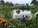 Charming pond featuring beautiful flowers, adding a touch of tranquility to the outdoor space at 3428 W County Road 4, Berthoud, CO 80513