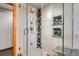 Modern shower with a glass door, built-in shelves, and mosaic tile accents at 3428 W County Road 4, Berthoud, CO 80513