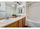 Bright bathroom featuring dual sinks, a shower over the tub, and a spacious vanity at 431 Black Feather Loop # 817, Castle Rock, CO 80104