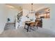 Dining area featuring wood table, stylish chandelier, and staircase with a view into the kitchen at 431 Black Feather Loop # 817, Castle Rock, CO 80104