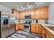 Modern kitchen with stainless steel appliances and wood cabinets at 431 Black Feather Loop # 817, Castle Rock, CO 80104