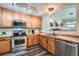 Modern kitchen with stainless steel appliances and wood cabinets at 431 Black Feather Loop # 817, Castle Rock, CO 80104