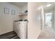 Convenient laundry room with washer and dryer, and extra shelving at 431 Black Feather Loop # 817, Castle Rock, CO 80104