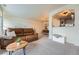 Bright living room featuring a comfortable leather sofa, neutral walls, and a view into the dining room at 431 Black Feather Loop # 817, Castle Rock, CO 80104