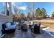 Outdoor living space with comfortable seating around a stone fire pit in a fenced backyard at 11043 Valleybrook Cir, Highlands Ranch, CO 80130