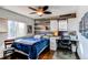 Cozy bedroom with a wood accent wall, built-in shelving, and a desk area, perfect for relaxing or studying at 11043 Valleybrook Cir, Highlands Ranch, CO 80130