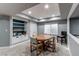 Basement dining room with built-in shelves, wood table, four chairs, and window with blinds at 11043 Valleybrook Cir, Highlands Ranch, CO 80130