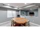 Basement dining room with wood table, four chairs, window with blinds, and view of living room at 11043 Valleybrook Cir, Highlands Ranch, CO 80130