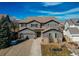 Beautiful two-story home featuring manicured landscaping, gray siding, and a concrete driveway leading to an attached two-car garage at 11043 Valleybrook Cir, Highlands Ranch, CO 80130