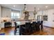 Modern kitchen with a large center island with seating, stainless steel appliances, and stylish pendant lighting at 11043 Valleybrook Cir, Highlands Ranch, CO 80130