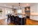 Beautiful eat-in kitchen with white cabinetry, stainless steel appliances, pendant lights, and french door access to outdoor space at 11043 Valleybrook Cir, Highlands Ranch, CO 80130