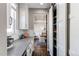 Open-concept kitchen featuring stainless steel appliances, a pantry, and stylish countertops with white cabinets at 11043 Valleybrook Cir, Highlands Ranch, CO 80130