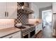 Modern kitchen featuring stainless steel appliances, sleek cabinetry, and a subway tile backsplash with patterned accents at 11043 Valleybrook Cir, Highlands Ranch, CO 80130