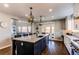 Gourmet eat-in kitchen featuring a large island with seating, stainless steel appliances, and hardwood floors at 11043 Valleybrook Cir, Highlands Ranch, CO 80130