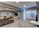 Basement living room with gray sofa, television, 'GAMEROOM' light feature, desk, and carpet at 11043 Valleybrook Cir, Highlands Ranch, CO 80130