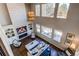 Living room boasting soaring ceilings, oversized windows for natural light, a fireplace, and a modern chandelier at 11043 Valleybrook Cir, Highlands Ranch, CO 80130