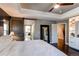 Main bedroom with wood accent wall, built-in storage and lighting, and ensuite bathroom at 11043 Valleybrook Cir, Highlands Ranch, CO 80130