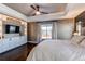 Main bedroom featuring a tray ceiling, ceiling fan, built-in storage and large window at 11043 Valleybrook Cir, Highlands Ranch, CO 80130