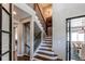 Elegant staircase featuring hardwood steps, iron railings, and modern chandelier at 11043 Valleybrook Cir, Highlands Ranch, CO 80130