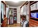 Spacious walk-in closet with custom wood shelving and ample storage space for clothes and accessories at 11043 Valleybrook Cir, Highlands Ranch, CO 80130