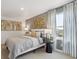 Stylish bedroom featuring neutral gray walls, a queen bed, and plenty of natural light at 43124 Kawana Gulch St, Elizabeth, CO 80107