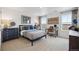 Bright bedroom with plush carpet, neutral decor, and ample natural light from two large windows at 43124 Kawana Gulch St, Elizabeth, CO 80107