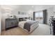 Well-lit bedroom with plush carpet, modern decor, and a large window with neighborhood views at 43124 Kawana Gulch St, Elizabeth, CO 80107