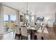 Elegant dining room with a contemporary chandelier, hardwood floors, and sliding glass door to backyard at 43124 Kawana Gulch St, Elizabeth, CO 80107