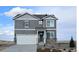 Charming two-story home with gray siding, stone accents, a two-car garage, and professionally landscaped front yard at 43124 Kawana Gulch St, Elizabeth, CO 80107