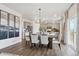Well-designed kitchen and dining area with stainless steel appliances, light gray cabinetry, and hardwood floors at 43124 Kawana Gulch St, Elizabeth, CO 80107