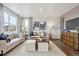 Bright and airy living room featuring hardwood floors, large windows, and stylish decor, perfect for entertaining guests at 43124 Kawana Gulch St, Elizabeth, CO 80107