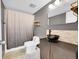 Contemporary bathroom with vessel sink, black fixtures, and modern shower curtain at 1226 S Monaco Pkwy # 308, Denver, CO 80224