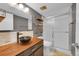 Modern bathroom with floating shelves, vessel sink, and glass-enclosed shower at 1226 S Monaco Pkwy # 308, Denver, CO 80224