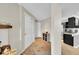 Neutral hallway with a coat closet and sightlines into the kitchen; featuring tile flooring at 1226 S Monaco Pkwy # 308, Denver, CO 80224