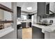 Updated kitchen featuring stainless steel appliances, dark cabinetry, and a modern countertop at 1226 S Monaco Pkwy # 308, Denver, CO 80224