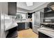 Well-lit kitchen showcasing stainless steel appliances, dark cabinets, and a charming window at 1226 S Monaco Pkwy # 308, Denver, CO 80224