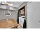 Laundry closet off dining area featuring washer, dryer, and built in shelving at 1226 S Monaco Pkwy # 308, Denver, CO 80224