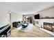 Open living room featuring hardwood floors, a fireplace, and a cozy sofa at 1226 S Monaco Pkwy # 308, Denver, CO 80224