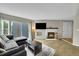 Spacious living room with a cozy fireplace, modern sofa, and sliding glass doors to the outside at 1226 S Monaco Pkwy # 308, Denver, CO 80224