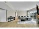 Large living room featuring an electric piano, neutral walls, wood floors, and natural light at 1226 S Monaco Pkwy # 308, Denver, CO 80224