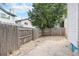 Enclosed backyard featuring a brick patio and gravel, offering a private outdoor space at 2238 S Nile Ct, Aurora, CO 80014