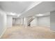 Spacious finished basement with carpet, neutral paint, and staircase leading to upper level at 2238 S Nile Ct, Aurora, CO 80014