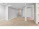 Finished basement featuring carpet, neutral paint, and access to utility area at 2238 S Nile Ct, Aurora, CO 80014