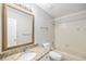 Bathroom with a large mirror, granite counter, and shower-tub combo with tile surround at 2238 S Nile Ct, Aurora, CO 80014
