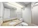 Bright bathroom featuring a large mirror, granite counter, and tub-shower combo at 2238 S Nile Ct, Aurora, CO 80014