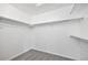 Walk-in closet with ample shelving and neutral carpeting, offering efficient storage space at 2238 S Nile Ct, Aurora, CO 80014