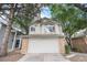 Charming two-story home with brick-accented garage, surrounded by mature trees at 2238 S Nile Ct, Aurora, CO 80014